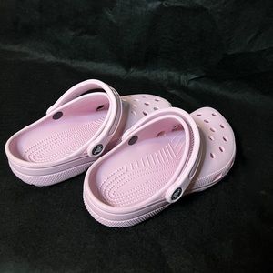 Light pink/purple crocs.